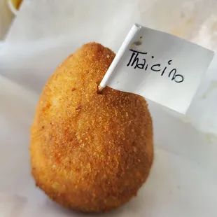 a fried donut with a sign on it