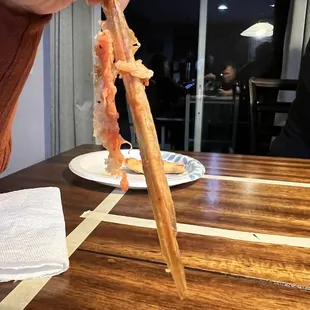 A large piece of wood BAKED INTO THE PIZZA!!