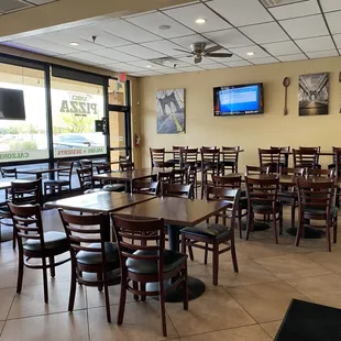 a large dining room with tables and chairs