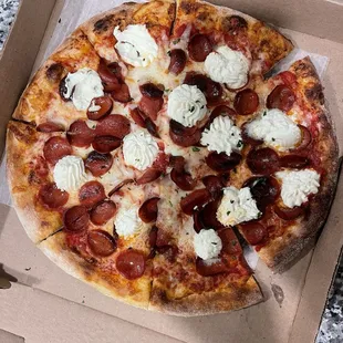 a pepperoni and mozzarella pizza in a box