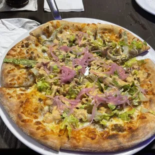 a pizza with various toppings on a white plate