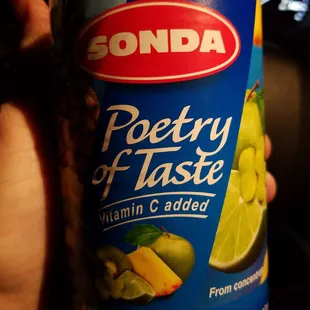 a person holding a bottle of soda