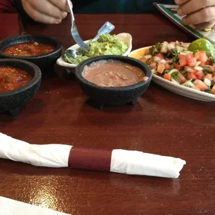 Chips, salsa, beans, guacamole, and pico de gallo.