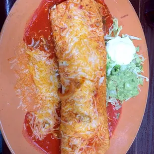 two enchillas on an orange plate