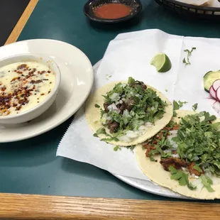 Queso fondido, carne asada taco and al pastor taco.