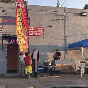 Rear entrance, from about 7:00 pm and on you have a taquero with hand made tortillas.