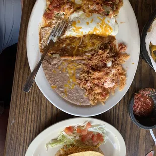 a plate of mexican food and a plate of tacos