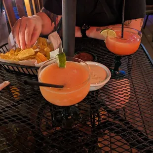 a person sitting at a table with drinks
