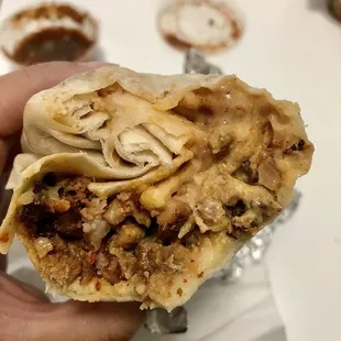 a hand holding a burrito