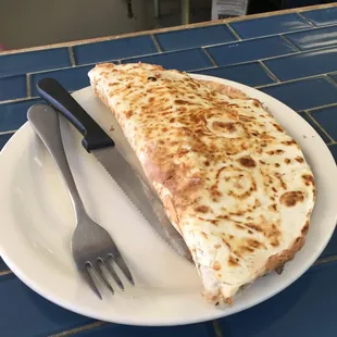 Specialty quesadilla with steak, beans, avocado, sour cream and cheese