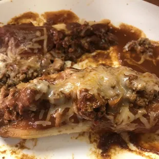 One single pork tamale, served with ground beef on top.