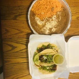 Three taco combo with a hearty serving of beans and rice for $9.99 including tax.