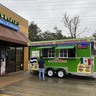 a man standing in front of a food truck