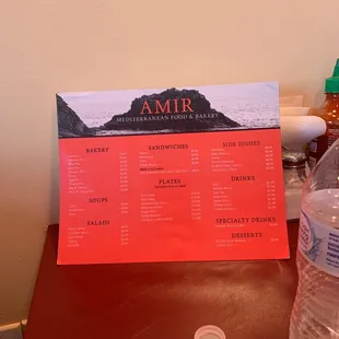 a menu and a bottle of water