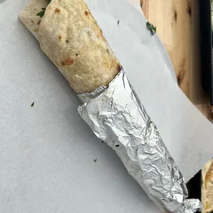 a burrito wrapped in tin foil