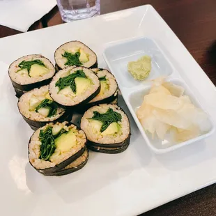 a plate of sushi and a bowl of chips