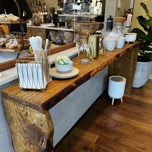 a wooden table with plates and utensils on it