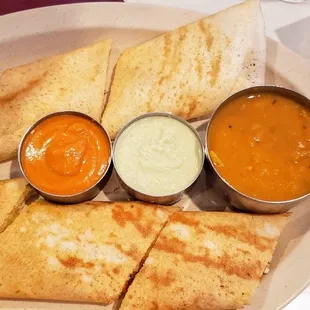 a plate of quesadillas and sauces