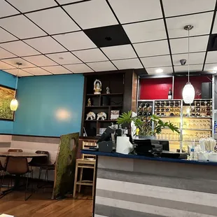 a restaurant with blue walls and wood floors