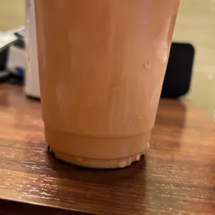 a cup of iced coffee on a table