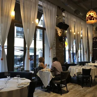 a dining area with tables and chairs