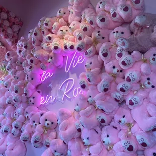 a large pile of pink teddy bears