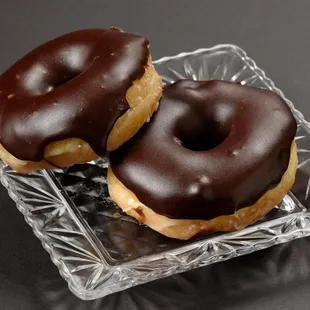 Chocolate covered glazed donuts.