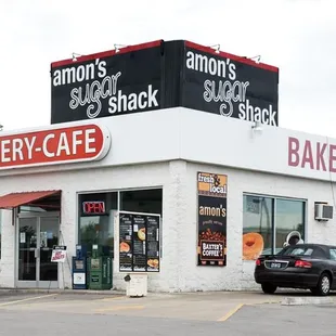 a bakery with cars parked outside