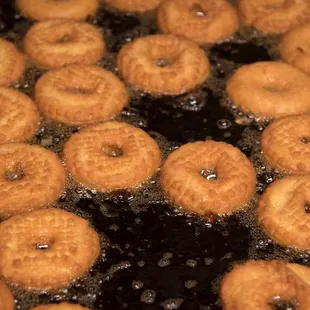 Fresh hot donuts in the making.