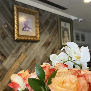 a vase of roses and orchids