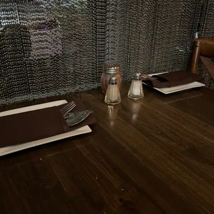 a wooden table with a knife and fork on it