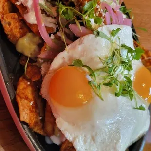 Red Chilaquiles Sunny Side Up with added chicken