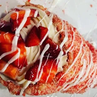a pastry with strawberries and cream