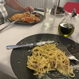 a plate of pasta and a glass of wine