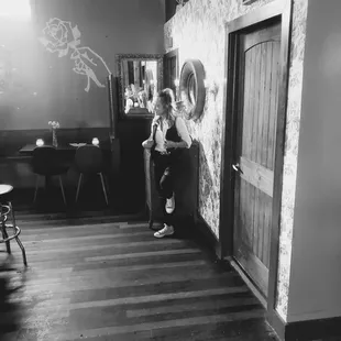 a black and white photo of a woman sitting on a chair