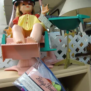 A vintage doll with a complete set of beauty parlor accessories.