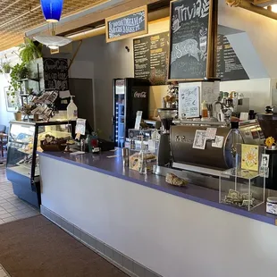a coffee shop counter with a variety of items