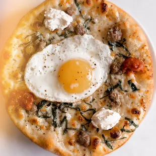 a pizza with an egg on top