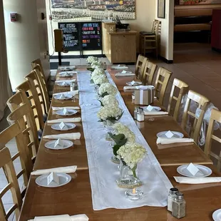 a long table with white flowers