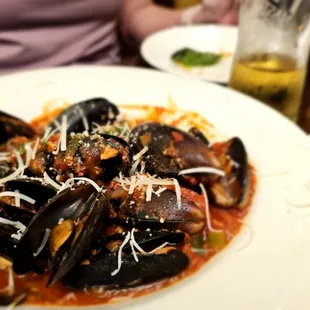 a plate of mussels and sauce