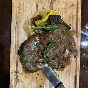 Rib eye with mushroom sauce, veggies and potatoes.