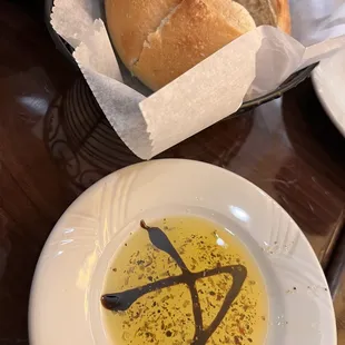 Fresh baked homemade bread with olive oil and herbs decorated with balsamic