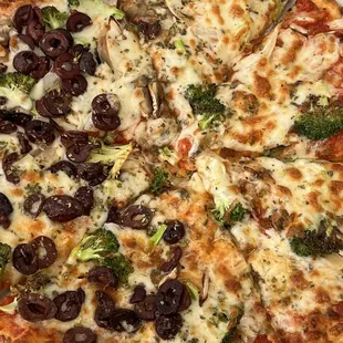 a pizza with broccoli and olives