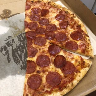 Half eaten pepperoni pizza.