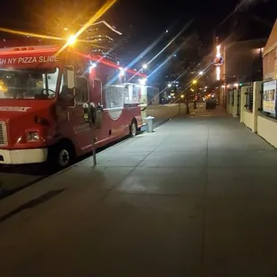 a red truck parked on the side of the road
