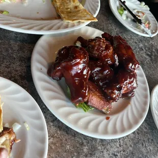 a plate of ribs and a plate of salad