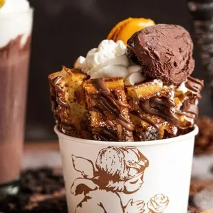 a cup of hot chocolate with whipped cream and cookies