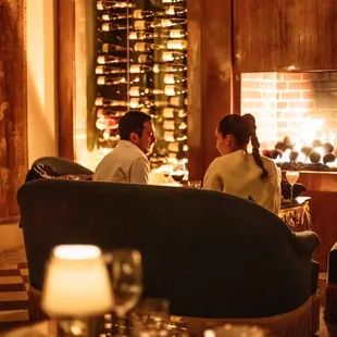 a group of people sitting in front of a fireplace