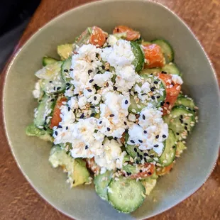 Avocado and roasted carrot salad with goat cheese, cucumber, and sesame seeds