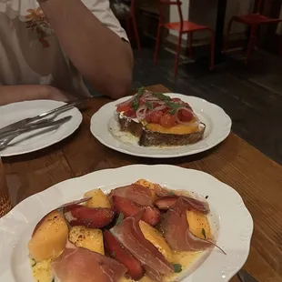 Small plates - melon, plums, speck, pepper relish (front), tomato toast (back)